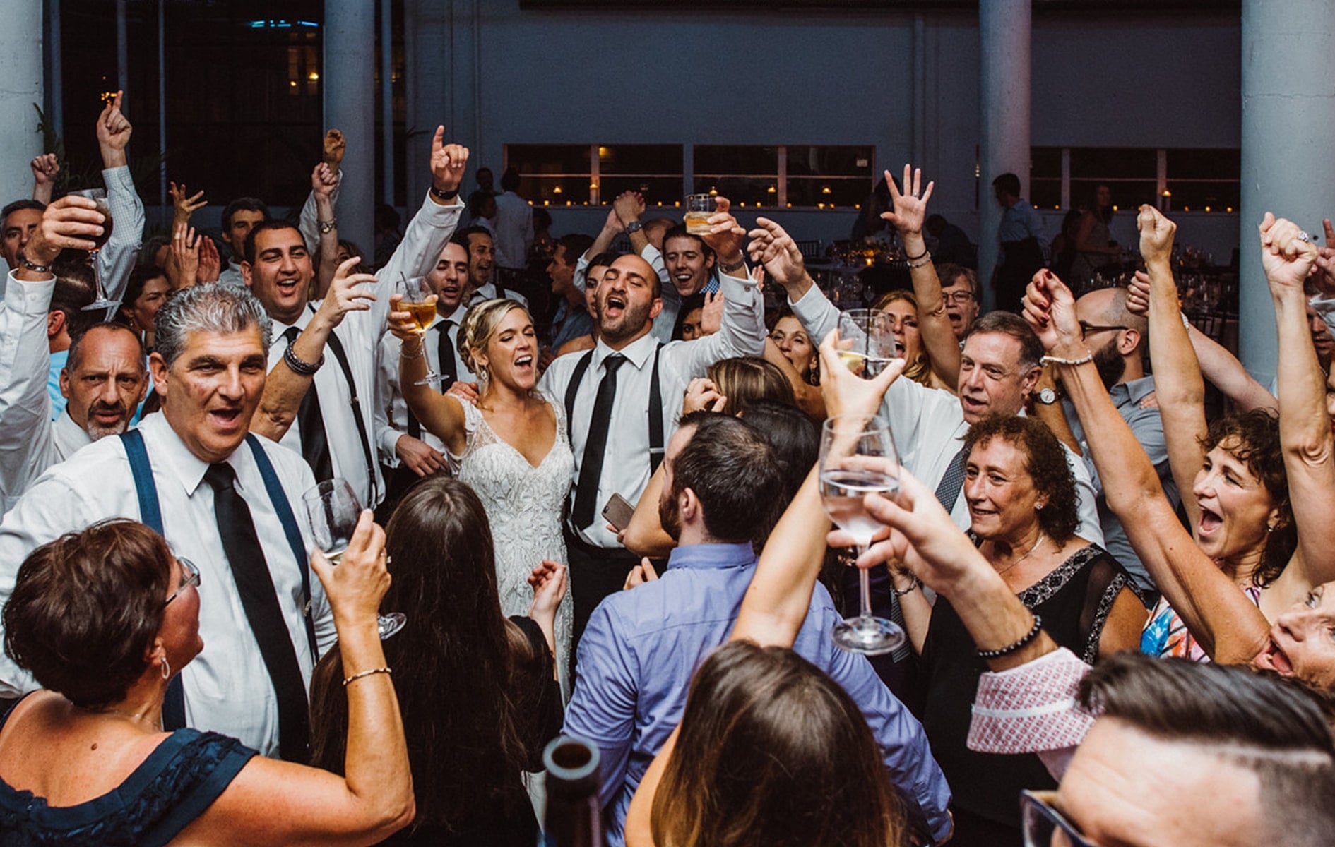 bride and groom dancing with friends on dance floor