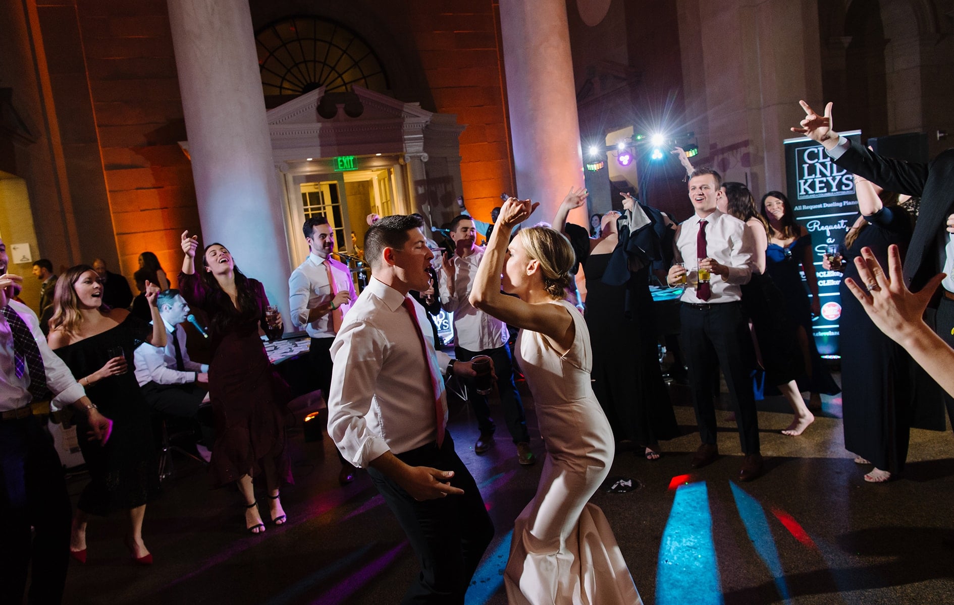 bride and groom dancing in the middle of crowd