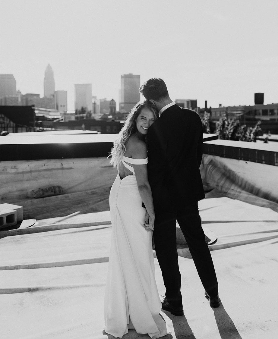 bride and groom taking portrait on rooftop
