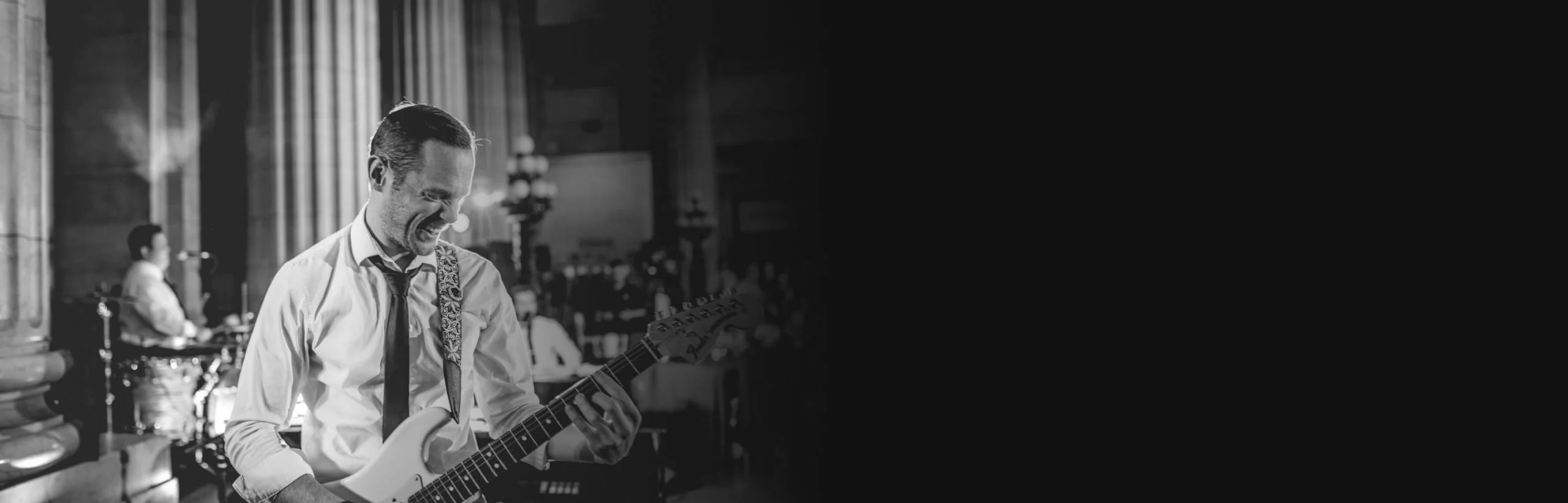 Gregg playing the guitar on stage close-up