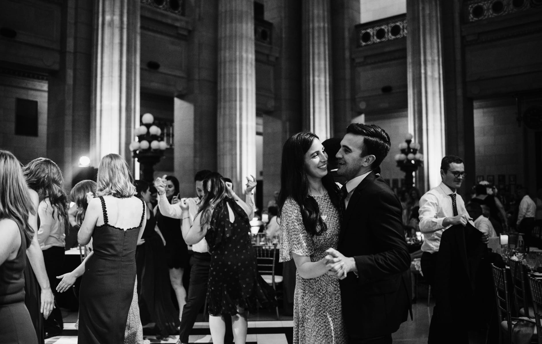 close-up of multiple people dancing at wedding