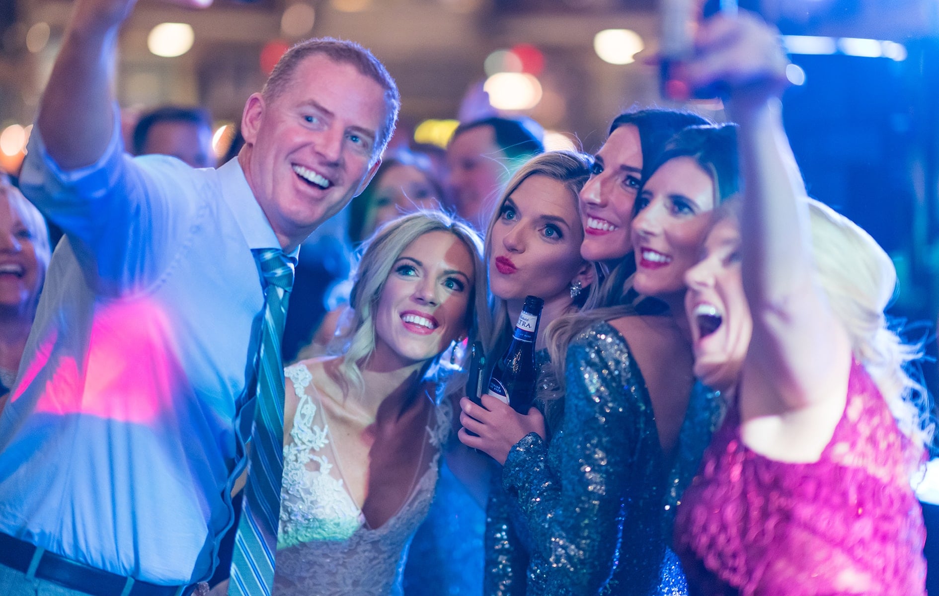 bride posing with wedding guests at the arcade in cleveland