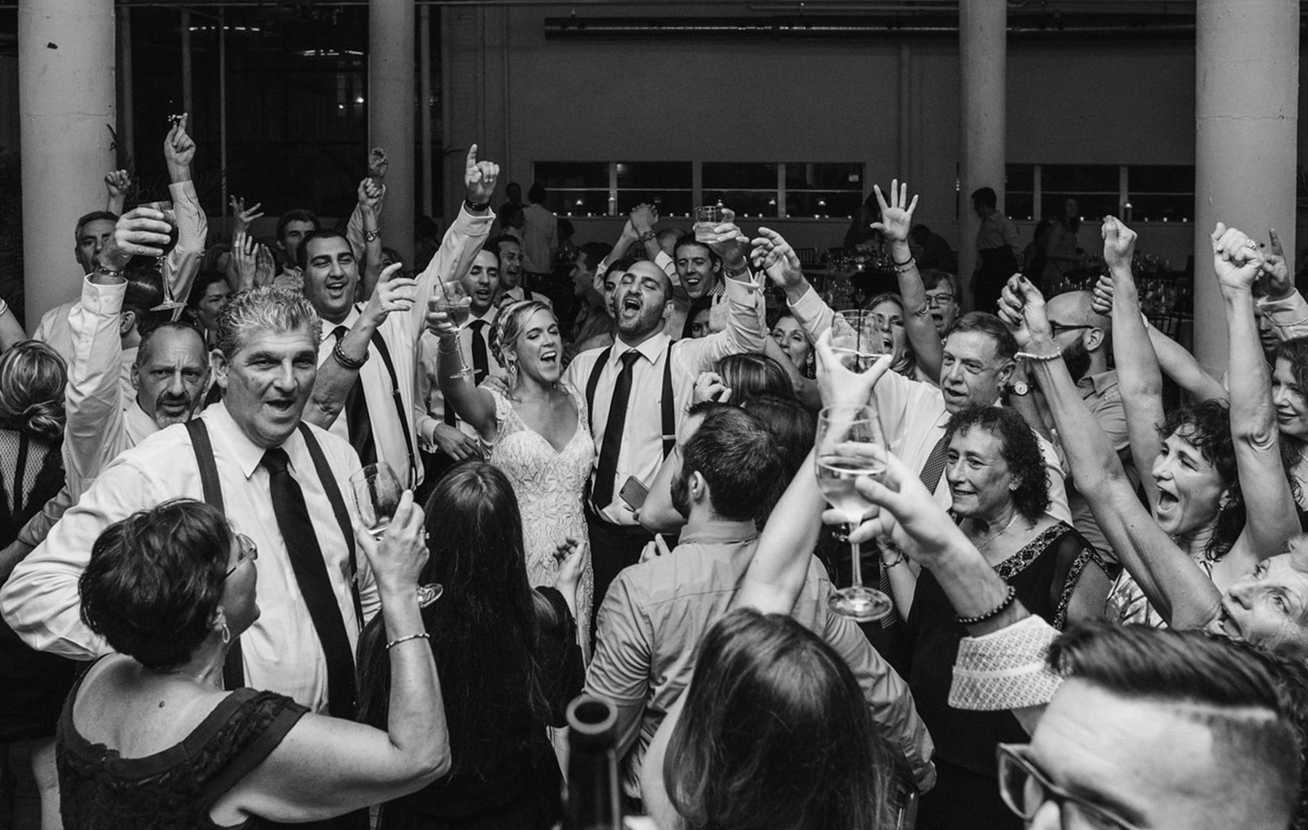 wedding guests cheer on the dance floor